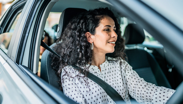 Person with curly hair in driver’s seat.