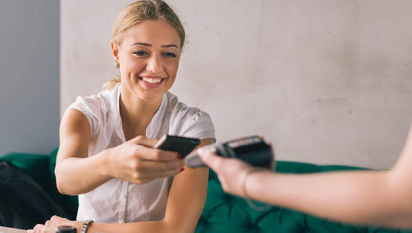 woman making payment with mobile wallet tap and go